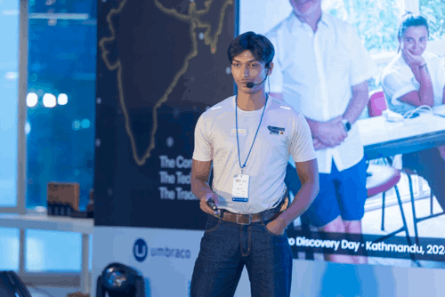 Vishal Tim on stage sharing his story — emotive, candid shot