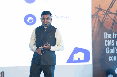 Nikhil presenting on stage — Umbraco Automation with MCP and AI Agents, title slide visible