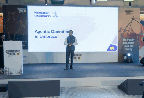 Nikhil presenting on stage — Umbraco Automation with MCP and AI Agents, title slide visible